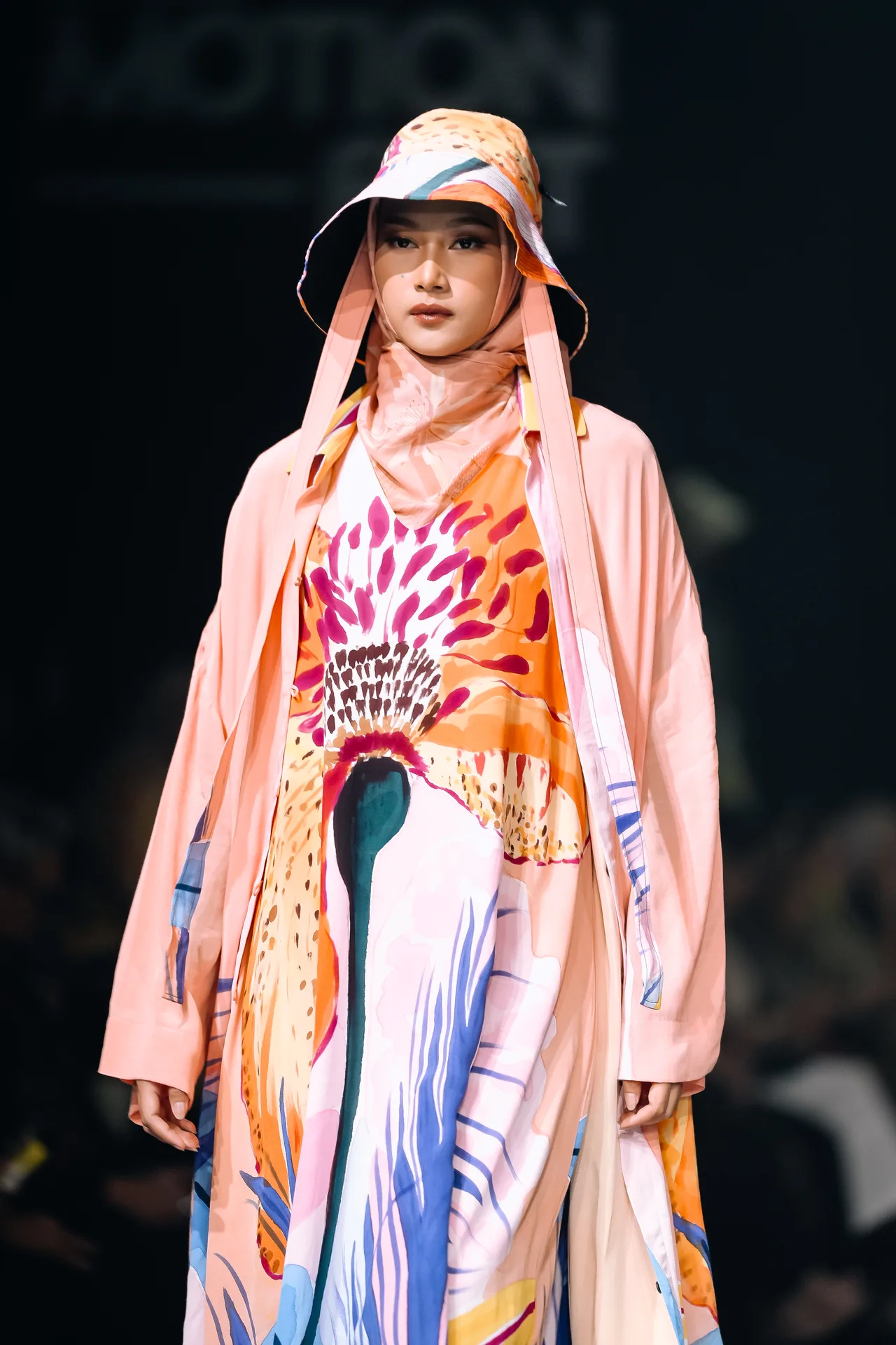Gina in a hand-painted crane gown and pink bucket hat